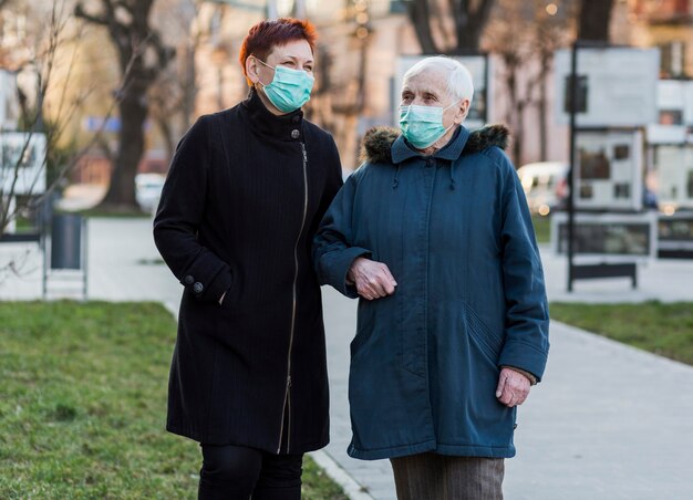 Front view of elder women in the city wearing medical masks