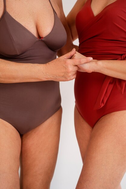 front view eldery women in swimsuits posing