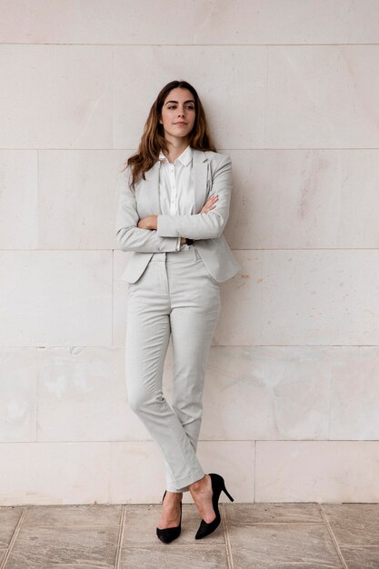 Front view of elegant businesswoman posing outdoors