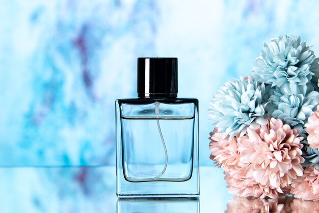 Front view elegant perfume colored flowers on blue blurred background