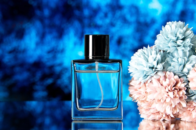 Free photo front view of elegant perfume colored flowers isolated on blue background