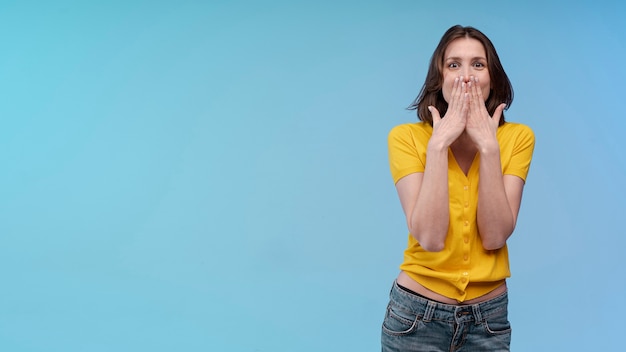 Front view of embarrassed woman posing with copy space