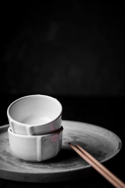 Front view of empty cups and chopsticks