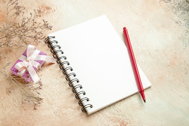 front view empty open notepad with red pencil