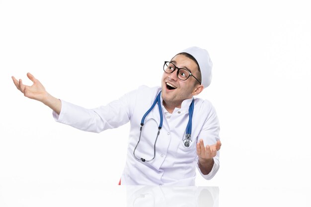 Front view excited male doctor in medical suit
