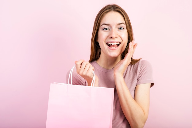 Free photo front view excited woman with pink background