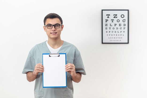 Front view of eye specialist holding notepad