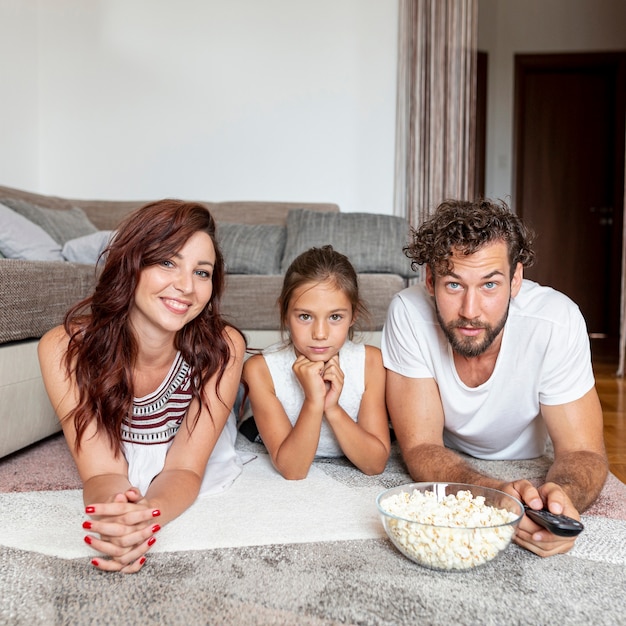 Front view of family laying on the floor