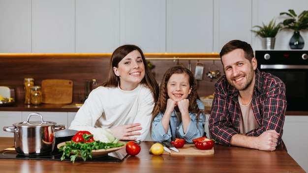 Front view of family posing in the kitchen