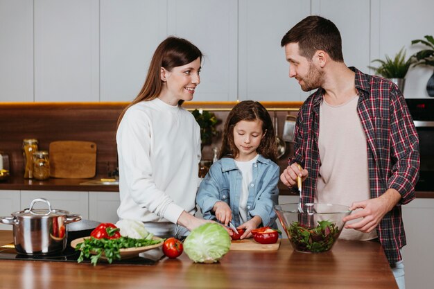 Front view of family preparing food in the kitchen