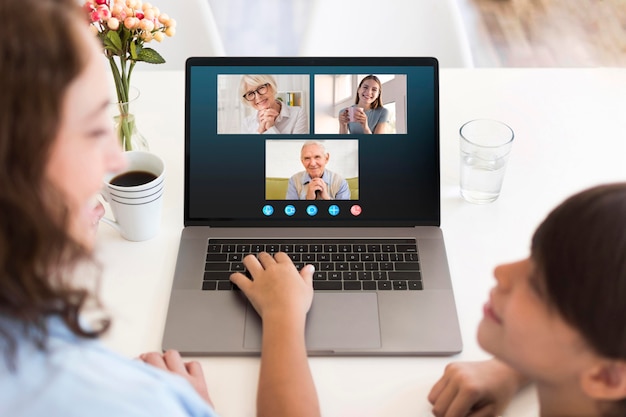 Front view family video call on laptop