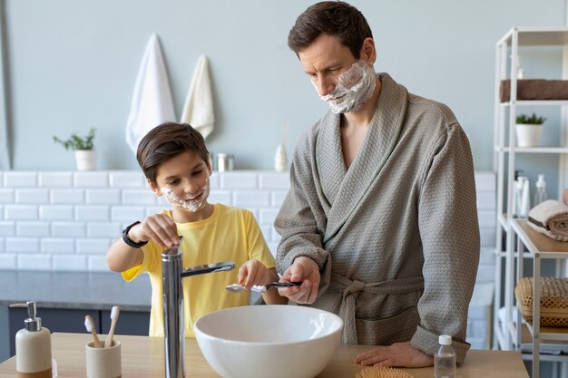 Front view father and boy shaving