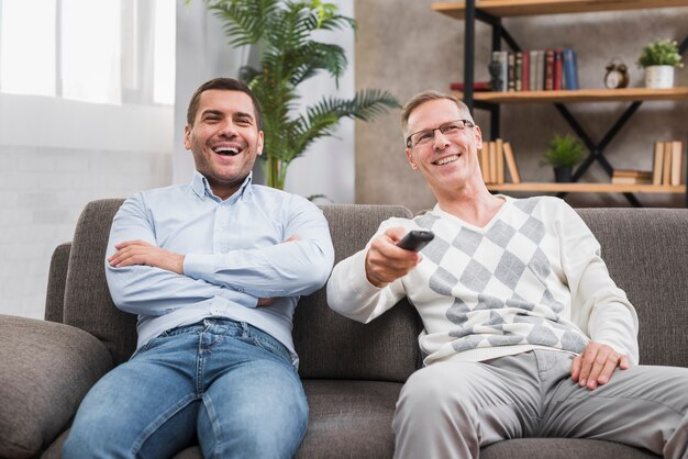 Front view of father and sitting on couch