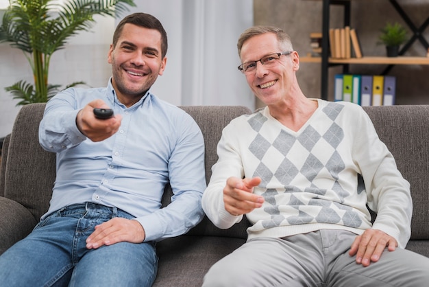 Free photo front view of father and sitting on couch