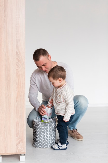 Front view of father and son at home with copy space