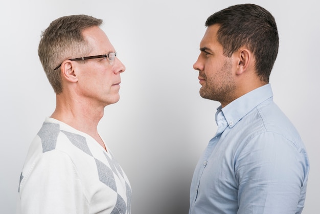 Front view of father and son staying face to face