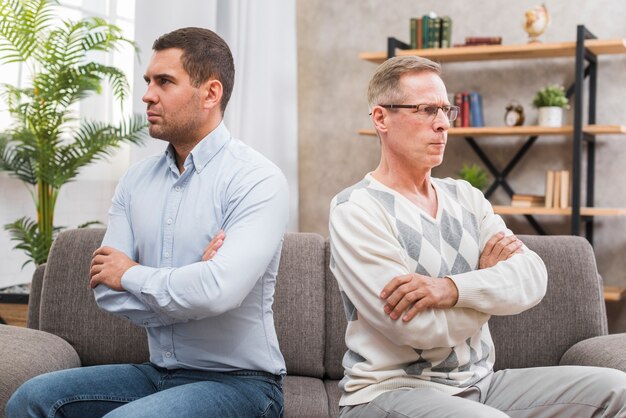 Front view of father and son not talking with eachother