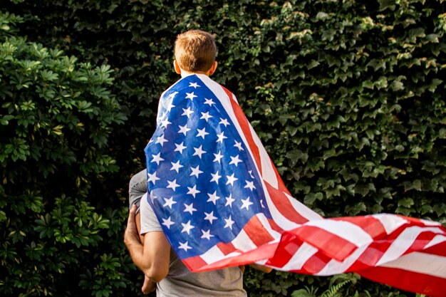 Front view father and son wearing usa flag