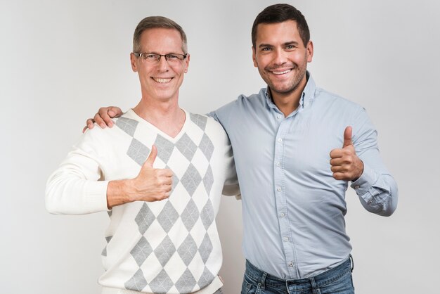 Front view of father and son with thumbs-up