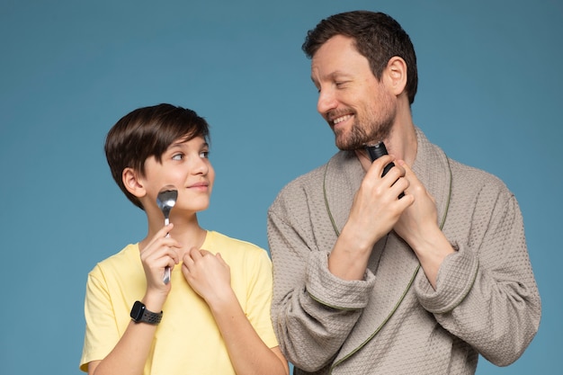 Front view father teaching kid how to shave