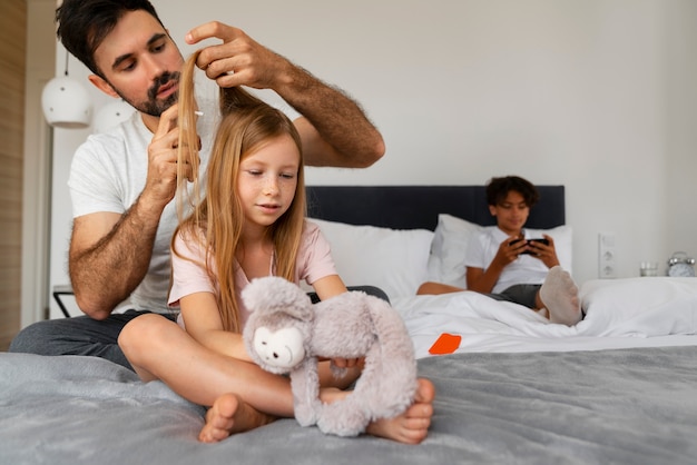 Front view father using lice treatment