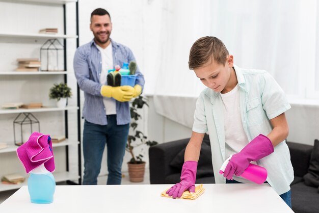 Front view of father watching son cleaning