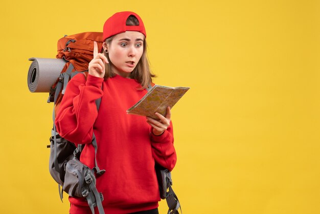 Front view female backpacker holding travel map surprising with an idea or question