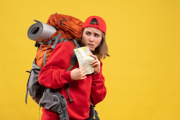 Front view female backpacker holding travel map