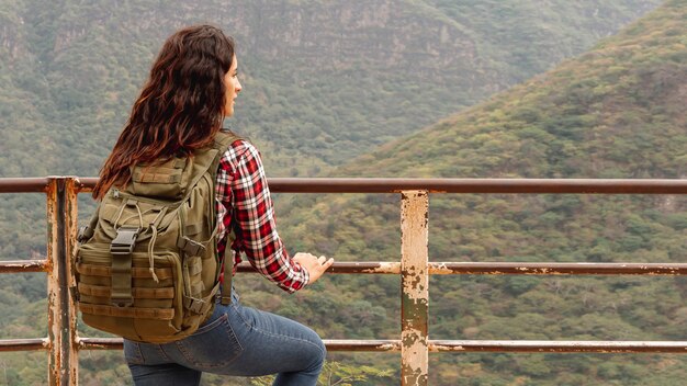 Front view female on bridge admiring nature