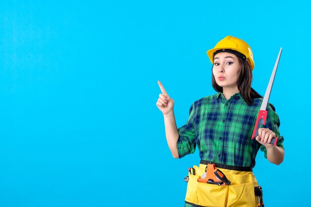 Front view female builder holding little saw