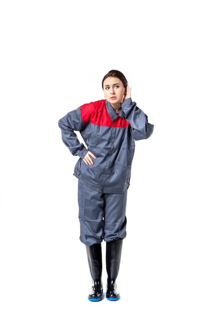 Free photo front view of female builder in special uniform listening on white wall