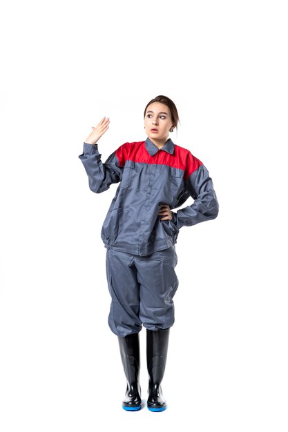 front view of female builder in uniform on white wall