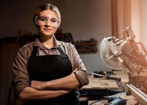 Front view of female carpenter posing at work