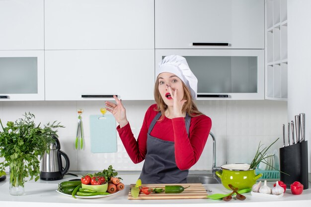 Front view female chef in apron saying something