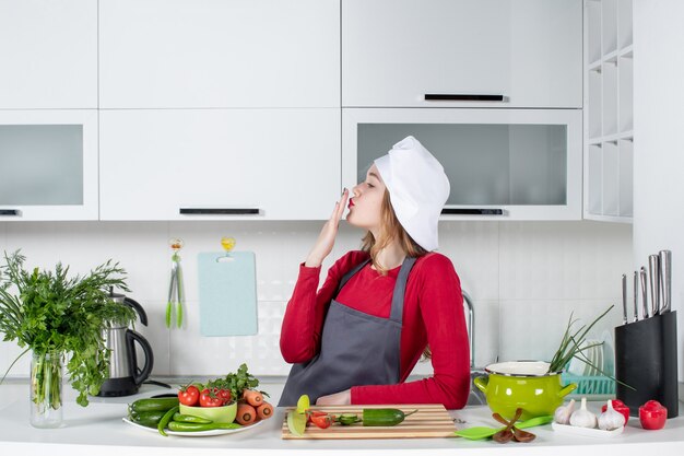 Front view female chef in cook hat sending kiss