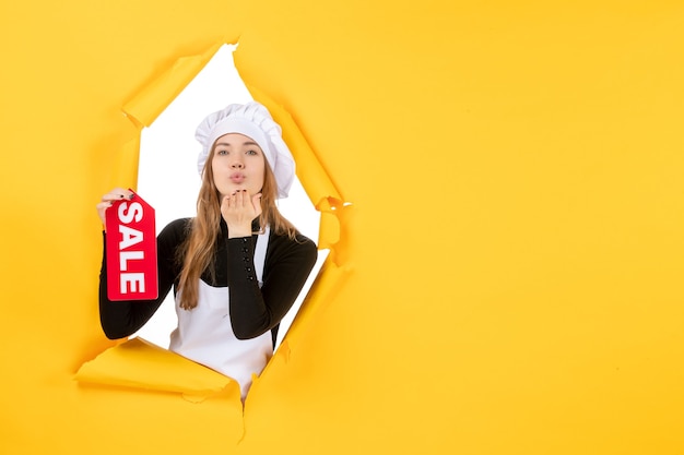 Front view female cook holding red sale writing on yellow color job photo kitchen cuisine emotions food
