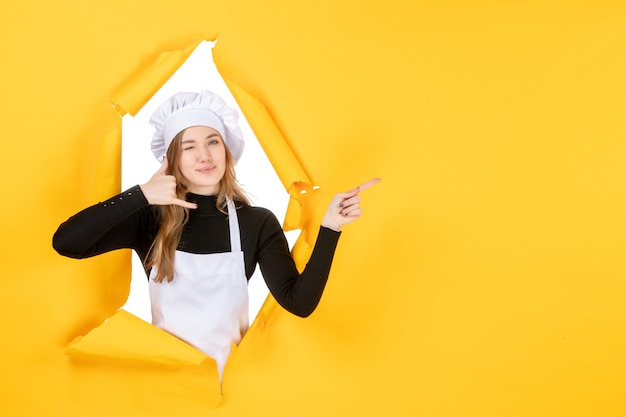 Front view female cook smiling on yellow kitchen photo food cuisine job color paper sun