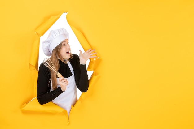 Free photo front view female cook in white cook cap on yellow color job emotion food cuisine kitchen photo sun