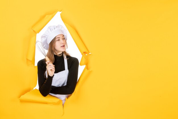 Front view female cook in white cook cap on yellow emotion food color cuisine job photo sun