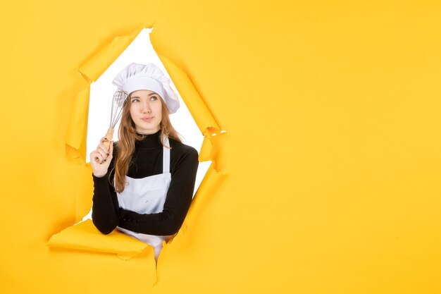 Front view female cook in white cook cap on yellow emotion food color cuisine kitchen job sun