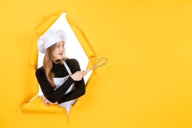 Front view female cook in white cook cap on yellow job emotions food color cuisine kitchen photo sun