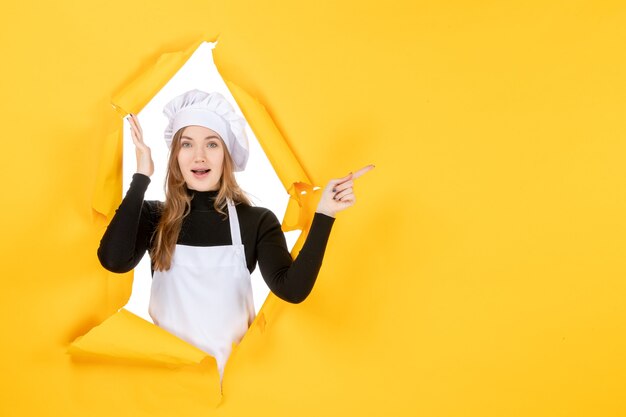 Front view female cook on yellow kitchen photo food cuisine job color paper sun