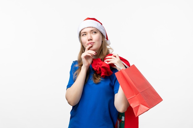 Front view of female courier holding present on white wall