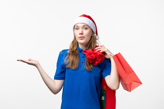 Front view of female courier holding present on white wall