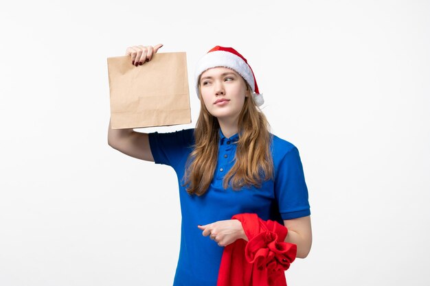 Front view of female courier with delivery on white wall