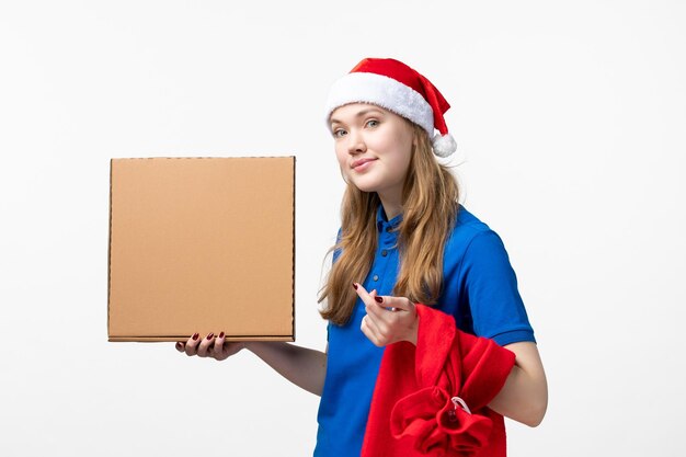 Front view of female courier with food box on white wall