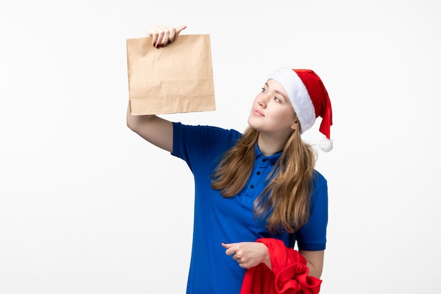 Free photo front view of female courier with food delivery on white wall