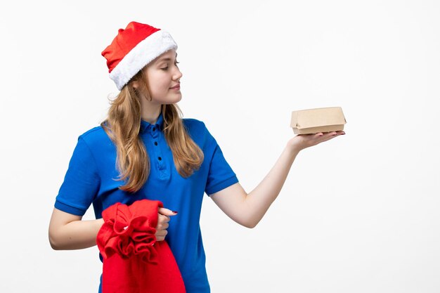 Front view of female courier with food delivery on white wall