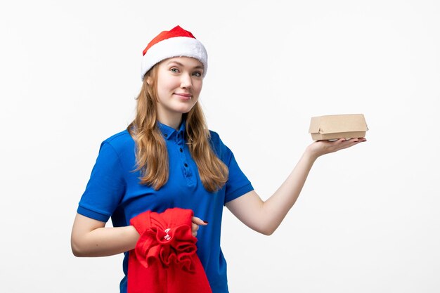 Front view of female courier with food delivery on white wall