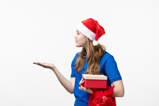 Front view of female courier with holiday present on the white wall